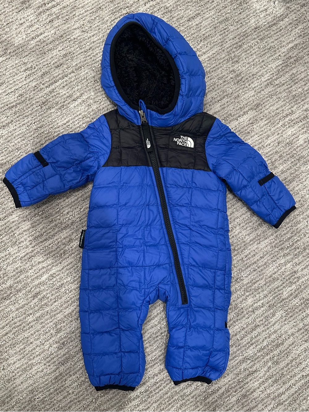 The North Face Blue and Black Quilted Hooded Baby One-Piece
